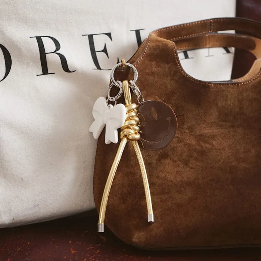 Orelia Cream Bow taskecharm creme sløjfe